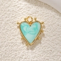 Detailed close-up of a heart-shaped pendant with gold frame and blue marble inlay texture - Gold Green Marble Heart