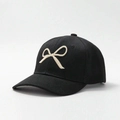 Close-up of cream bow embroidery on high-quality black cotton twill baseball cap - One Size / Black