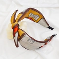 Detail of floral print wide headband with decorative bow knot in ginger and brown colors - Yellow Geometric Print Bow Headband