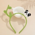 Close-up of handmade green knitted headband featuring a cute 3D crochet panda detail - Red Panda