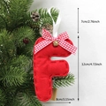 Red felt letter F Christmas ornament with plaid bow and bell hanging on a pine tree - F-Bell