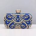 Close-up of intricate floral rhinestone patterns on a luxury blue evening clutch bag - Blue