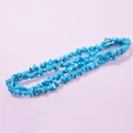Irregular natural turquoise stone necklace with bright blue-green finish on pink background - Light Blue