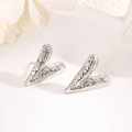 Detailed view of silver heart earrings with textured hammered finish on ceramic tray - Hammered Irregular Heart-Silver