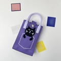Close-up of lavender knitted phone bag featuring a cute black cat and top handles - Sleeping Cat Purple