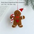 Brauner Lebkuchenmann aus Plüsch mit Weihnachtsmütze und Zuckerstange als Deko - Lebkuchenmann B