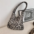 Détail de la texture et du design du cabas en peluche léopard dans un décor épuré - Sac Hobo / Gris