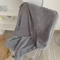 Gray waffle weave coral fleece bath towel with soft honeycomb texture on modern chair - Starry Grey Pineapple Grid