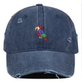 Close-up of colorful parrot embroidery on distressed navy blue washed denim baseball cap - Navy Blue