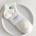 White cotton low cut socks featuring green NA letter embroidery and ribbed cuffs - One Size / Cream