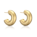Close-up of golden C-shaped hoop earrings with unique hammered metal texture and reflection - Hammered Texture C-Shaped Earrings
