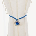 Blue floral curtain tieback with woven rope and jewel pendant on beige drapes - Heart of the Ocean Tieback