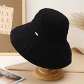 Black wide-brim sun hat with metal logo on wooden stand, foldable cotton fisherman hat - M(56-58cm) / Black