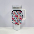 Detailed view of white tumbler with floral zipper pouch and secure ergonomic handle - No. 1 Green Red Flower