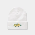 Detailed close-up of white knitted beanie featuring sunflower embroidery and soft texture - Flower / White