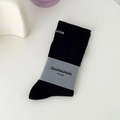 Classic black cotton mid-calf socks featuring vertical ribbed texture and white lettering - Black