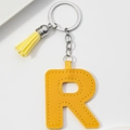 Detail of yellow PU leather letter R keychain with matching tassel and silver ring - Yellow-Letter R