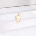 Minimalist gold titanium steel ring with heartbeat wave design on a white wavy pedestal - Heartbeat Gold