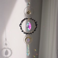 Golden sun and moon crystal suncatcher with black gravel and rainbow prisms - Obsidian