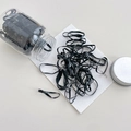 Elastic black hair ties in a clear storage jar with a silver metallic screw lid - Large Ring Pure Black Approx 100 Pcs (Jar)