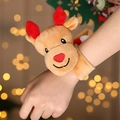 Plush Christmas reindeer snap bracelet for kids worn by a model against festive bokeh light - Plush Reindeer