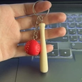 Miniature red baseball keychain featuring a wooden bat and yellow stitched leather ball - Red