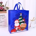Blue Christmas non-woven gift bag featuring Santa and tree with Feliz Navidad print - Christmas Blue Large