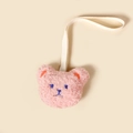 Close-up view of a cute pink plush bear pacifier clip with a cream fabric strap - Dusty Pink