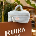 Light blue plush fleece makeup bag with top handle and decorative zipper ribbon - Blue