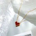 Elegant gold chain necklace featuring a red heart pendant with beaded edge on white texture - Necklace / Red Mother of Pearl