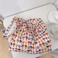 Détail d'un sac cabas en coton doux avec motifs imprimés colorés sur table blanche - Garçon Fille