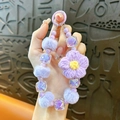 Ciondolo fatto a mano con fiore all'uncinetto viola e perline di pelliccia sintetica - Viola