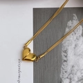 Detail view of double snake chain necklace featuring a gold polished heart pendant - Gold