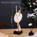 Modern gold ballerina sculpture with white pleated skirt on a black square base - Gold Ballet Standing B
