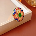 Close-up of vintage gold-plated ring with colorful enamel and central green gemstone - Vintage Enamel Green Gemstone Statement Ring