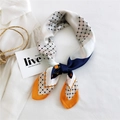 Navy and orange geometric silk scarf tied in a stylish knot on minimalist background - New Grid Orange Edge