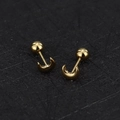 Macro shot of 16G gold crescent moon studs with ball screw backs in polished finish - Polished Moon / Gold