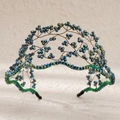 Detail of handcrafted blue and green crystal beads on a woven wire bridal headband - Green