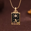 Macro shot of gold tarot pendant with black enamel, star pattern and zircon inlay - Gold (X6042GD)