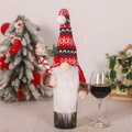 Knitted Christmas gnome wine bottle cover with white beard and candy cane on a bottle - Holding Cane Style