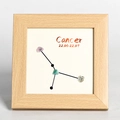 Wooden frame with Cancer constellation design made of natural raw crystals and black lines - Cancer