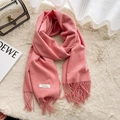 Sciarpa invernale rosa effetto cashmere con frange ed etichetta su fondo di peluche - Arancione