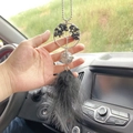 Macro detail of Tree of Life car pendant with black gemstones and elegant feathers - Black