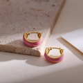 Close-up of French vintage pink enamel gold hoop earrings on beige marble stone - Pink
