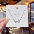Silver meteor pendant necklace with zircon stones on a white fashion display card - X683 Silver Meteor Star
