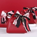 Red faux leather wedding favor gift bag with decorative patterned silk ribbon handle - Red
