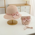 Close-up of pink straw hat and mini bag set with polka dot bows for kids' sun protection - Hat + Bag Set / Pink