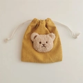 Close-up of yellow corduroy drawstring bag with a cute plush bear head decoration - Ginger (Milk Tea Bear)
