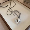 Retro hollow silver heart pendant on black cord resting on vintage book pages - 23# Necklace-Silver