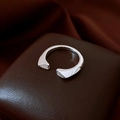 Macro view of silver open ring with zircon stones on a premium leather jewelry box - Silver Minimalist Bead Style